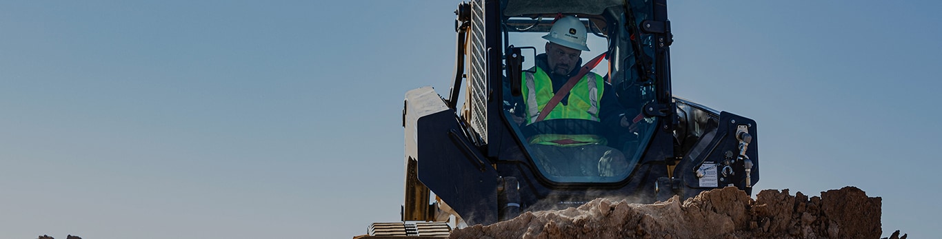 333G CTL operator dozes a pile of dirt