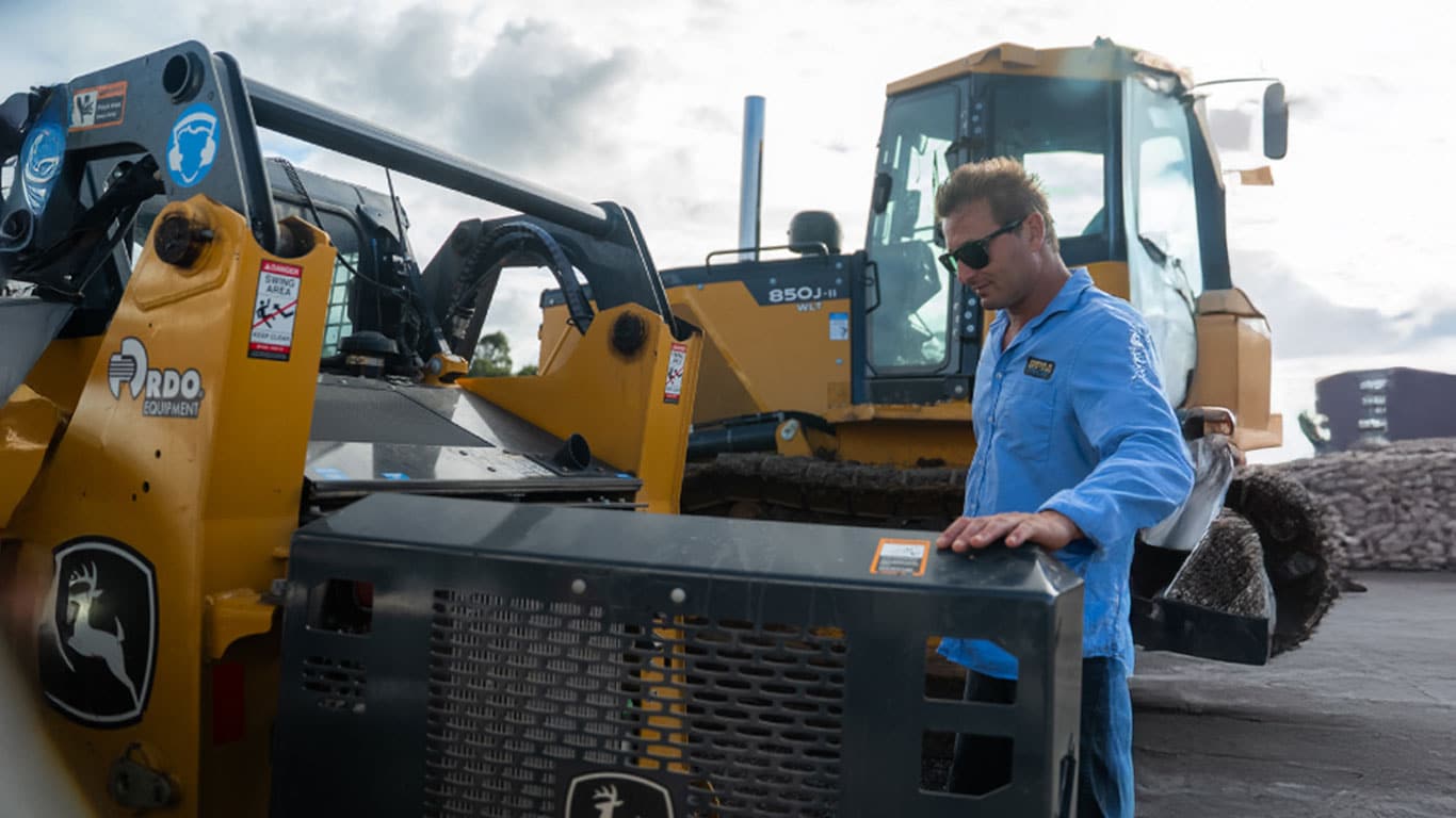 RPM Pro Civil customer standing in front of a machine