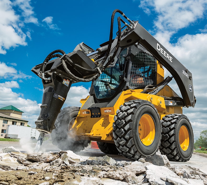 332G Skid Steer Loader breaking concrete with hydraulic rock breaker attachment