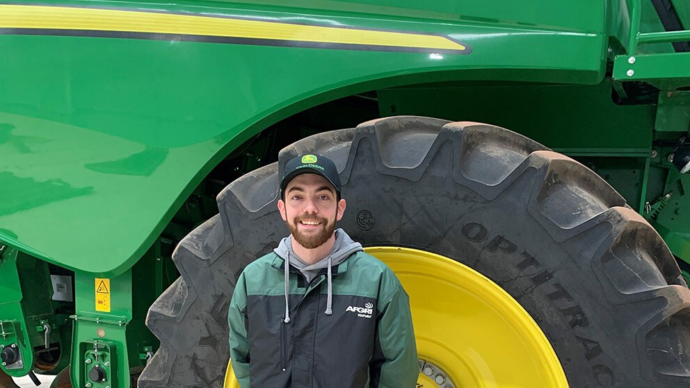 Dillon James in front of John Deere equipment