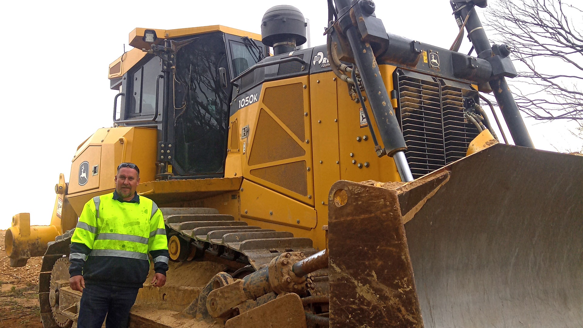 Workshop manager, Luke Anning in front of a John&nbsp;Deere machine