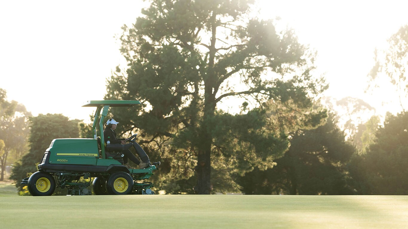Brody Cooper on the fairway mower on the golf course