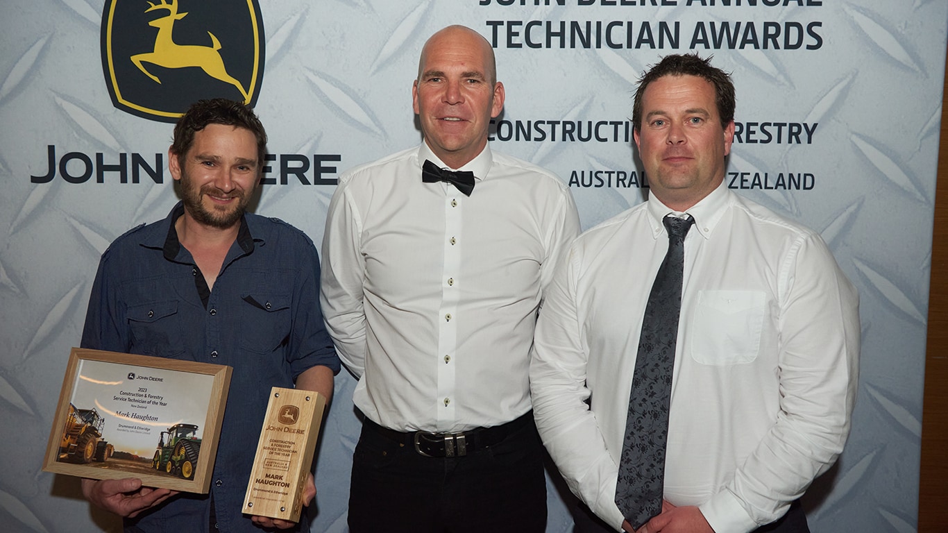 Mark Haughton smiling with his awards