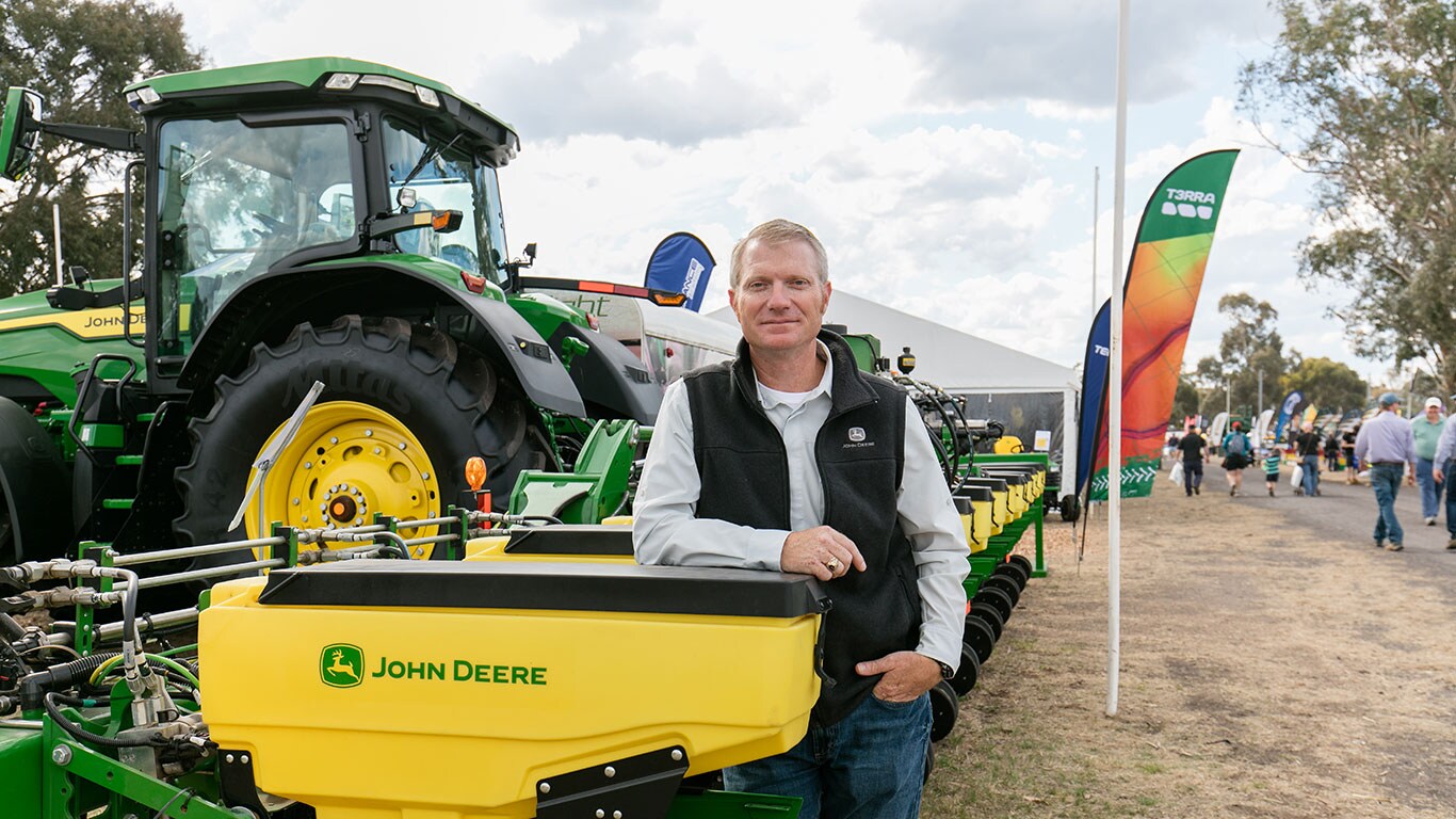 Paul Richardel standing next to the 1725C Planter at the AgQuip farm show.