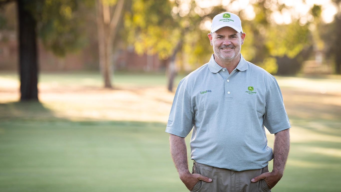 Terry Vogel standing on the golf course smiling