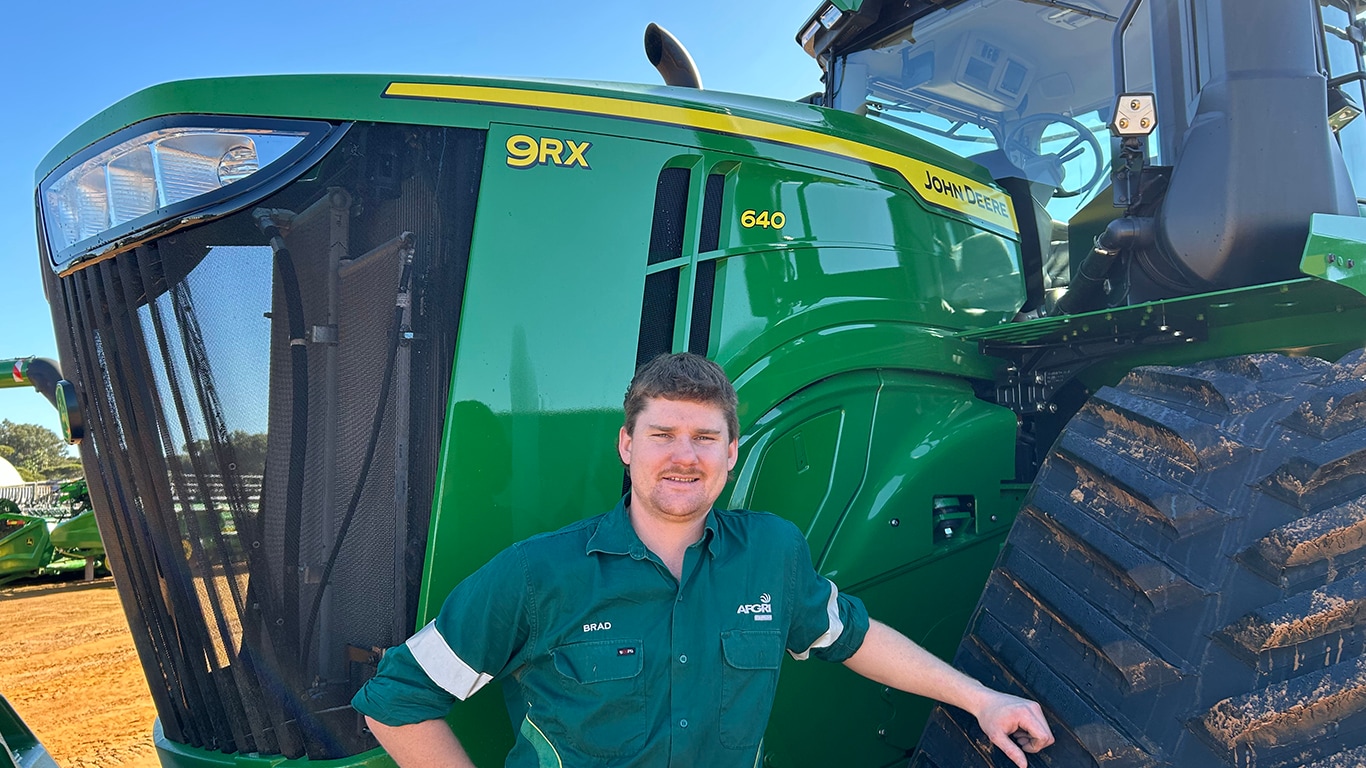 Brad Skinner smiling in front of a 9RX 640 tractor