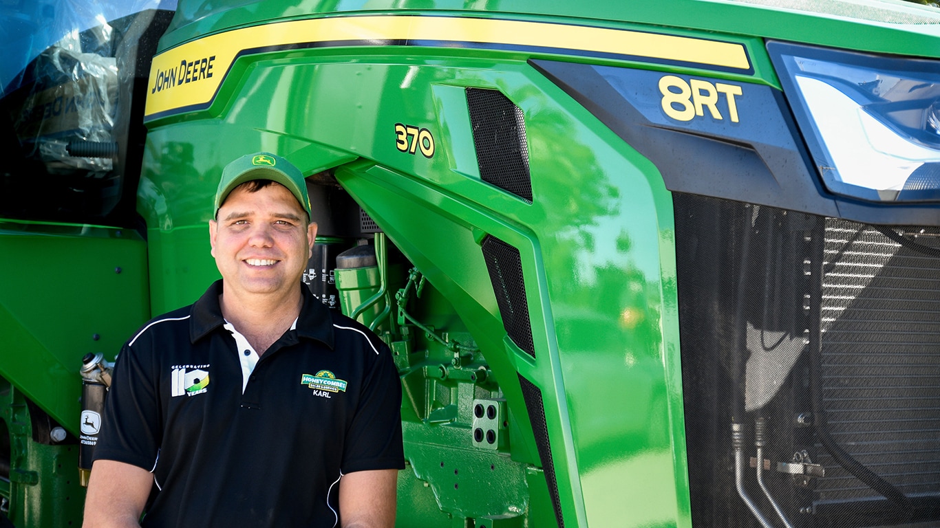 Karl Moschella smiling in front of a 8RT 370 tractor