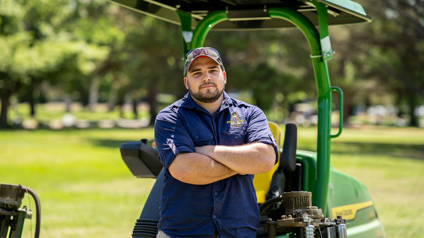  Luke Nakkan, Looking direct at camera, golf course behind him in background.