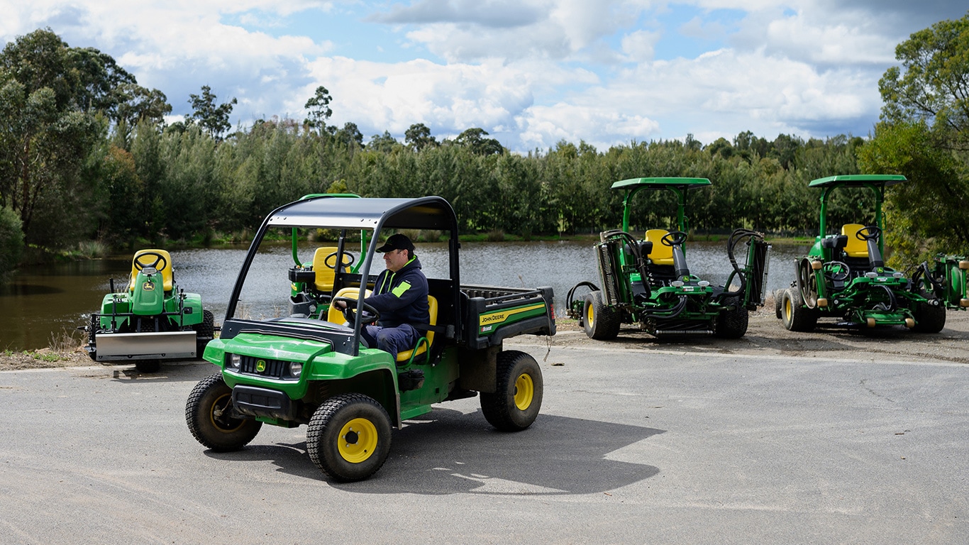 four John Deere golf vehicles