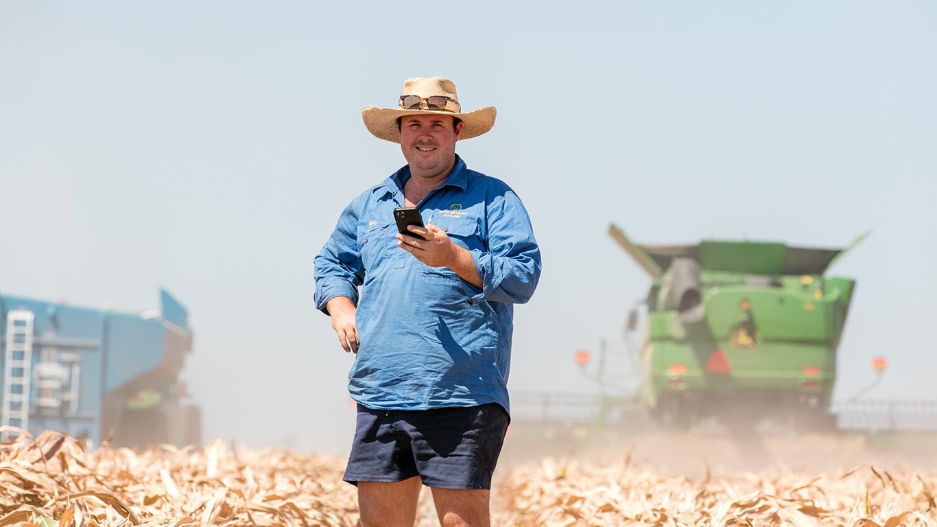 Farmer Henry Dight in a field with machines