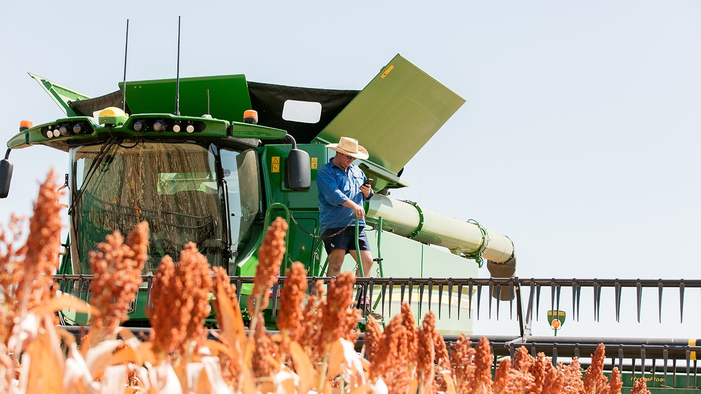 Henry Dight standing on the steps of a combine harvester