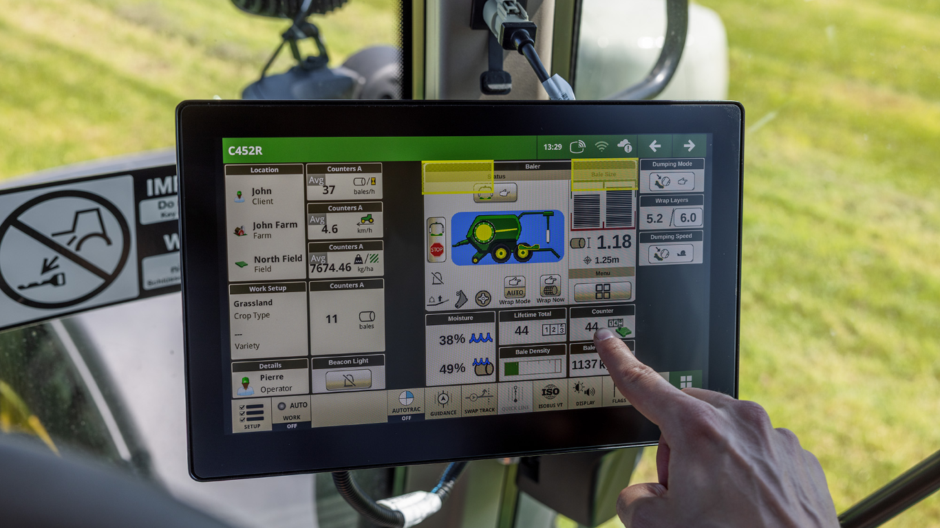A digital touchscreen inside a tractor cabin.