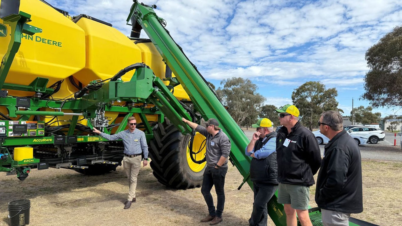 Alex Conterno showcasing John Deere equipment to staff, customers.