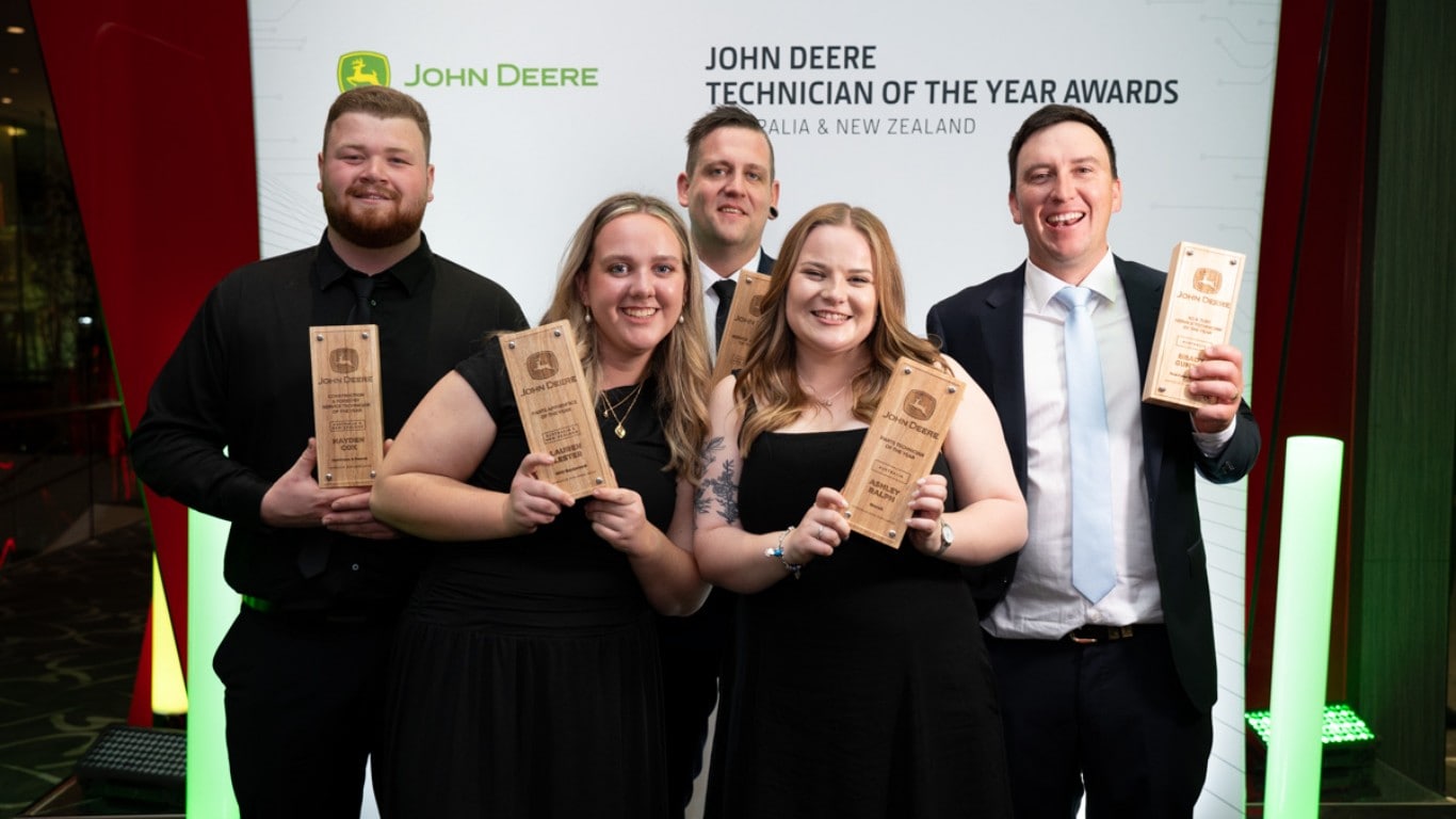 Five award recipients holding plaques at the John Deere Technician of the Year Awards.