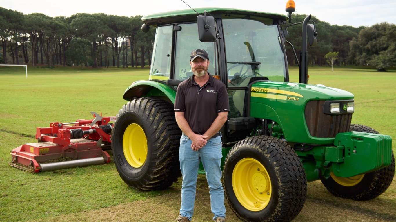 Man standing in front of John Deere 5075E.