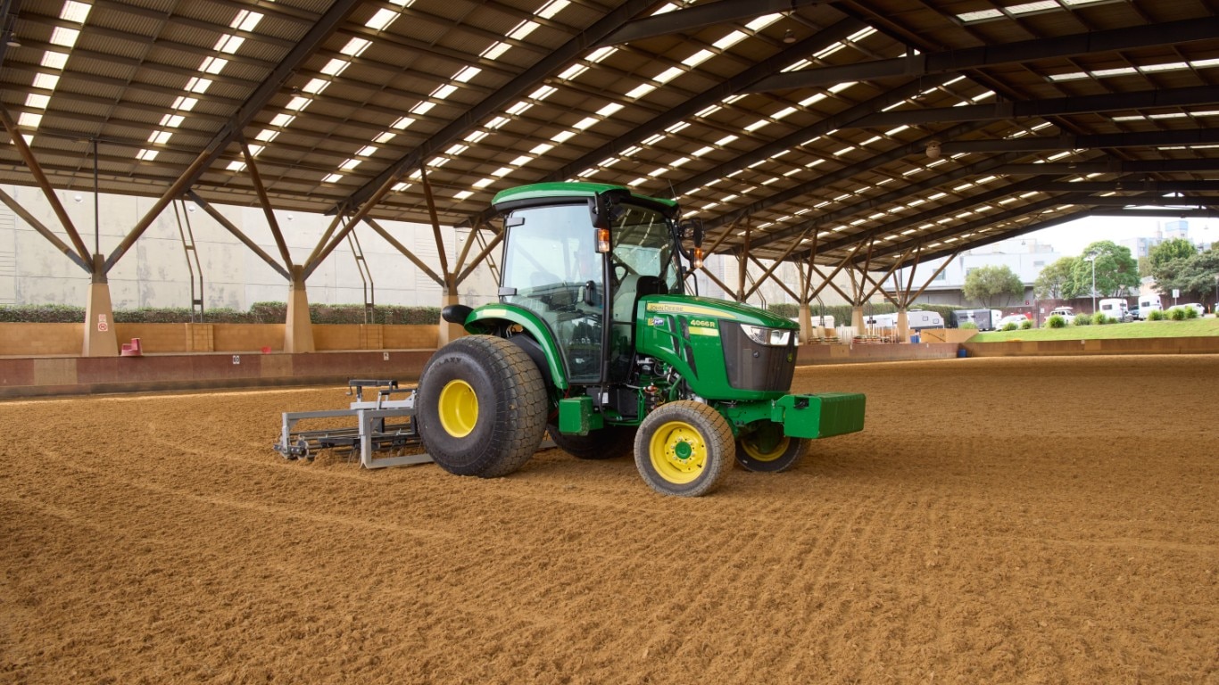 John Deere 5075E grading an equestrian arena.