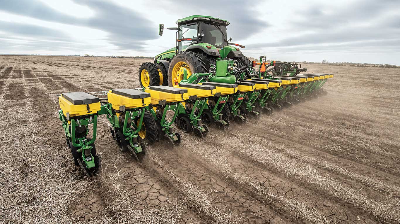 John Deere tractor with planting implement in a fallow field