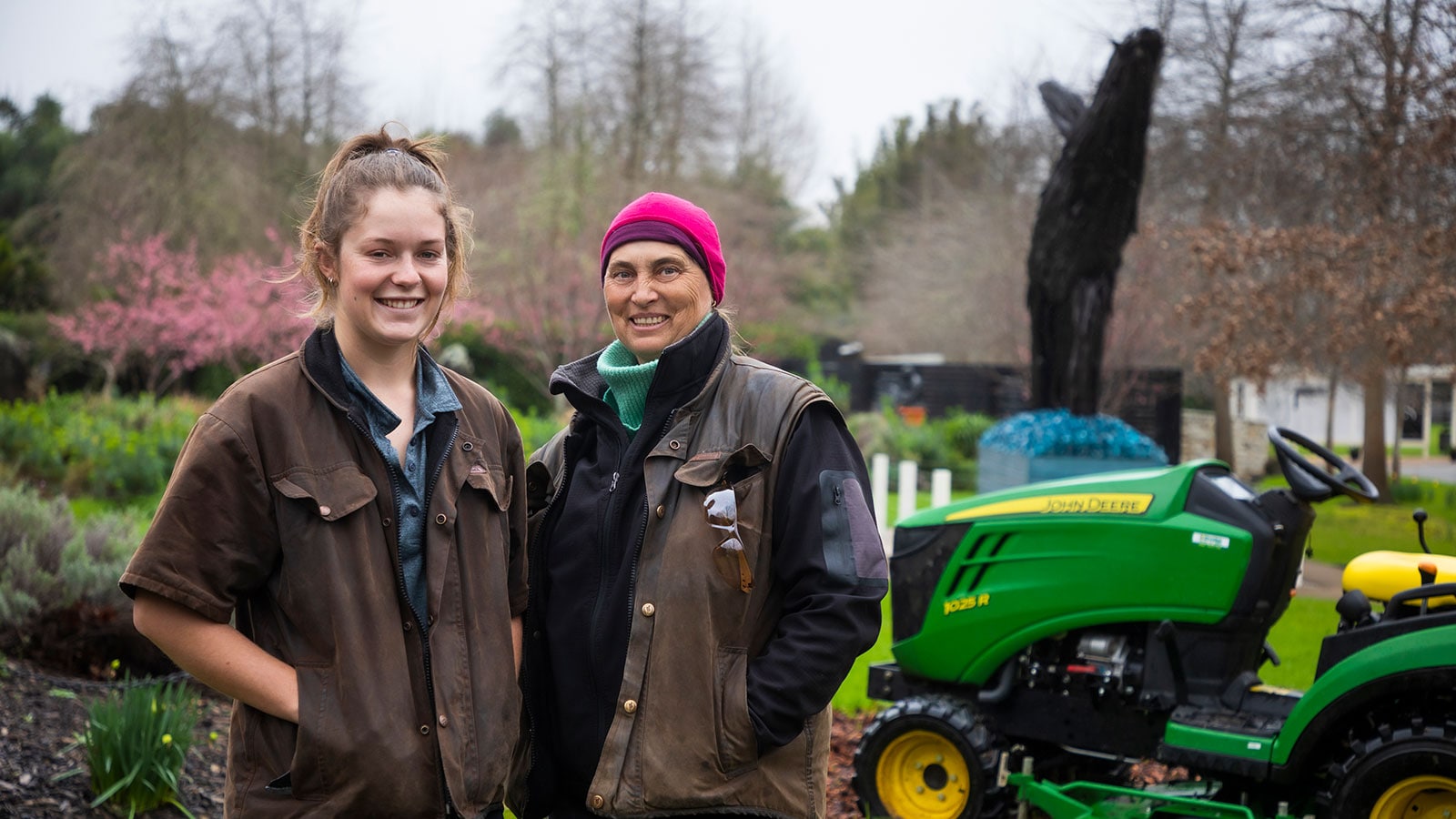  Jamie and Tina standing in front of mower at the Sculptureum Gardens New Zealand.