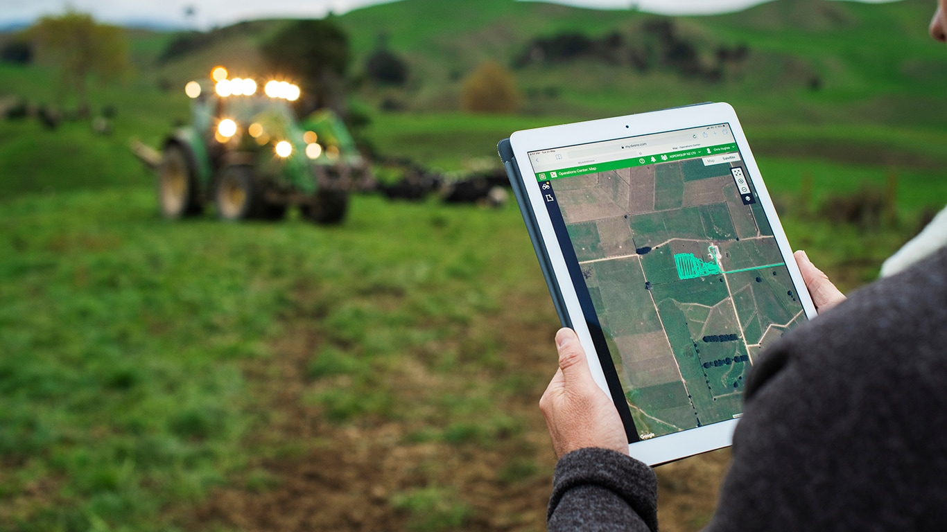 a person touching a tablet display in a field