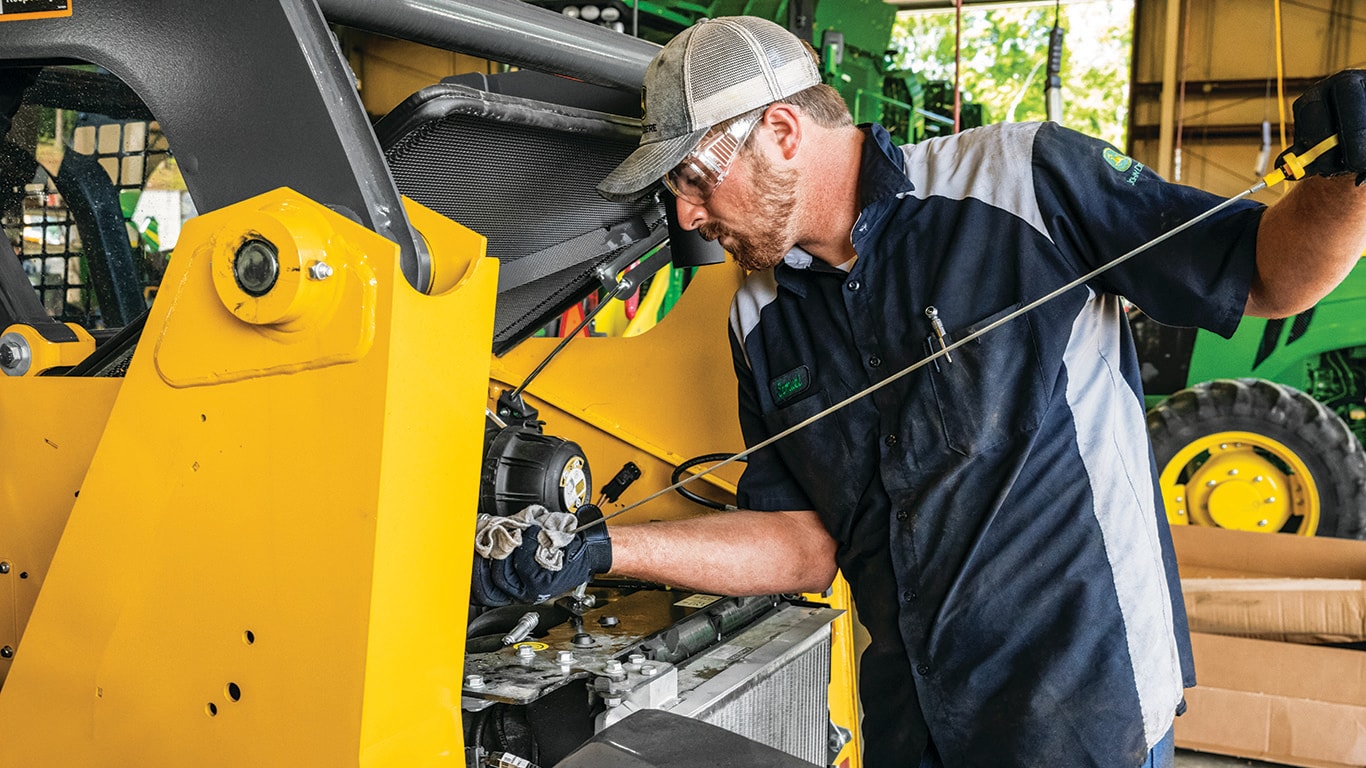 a man cleaning an engine part