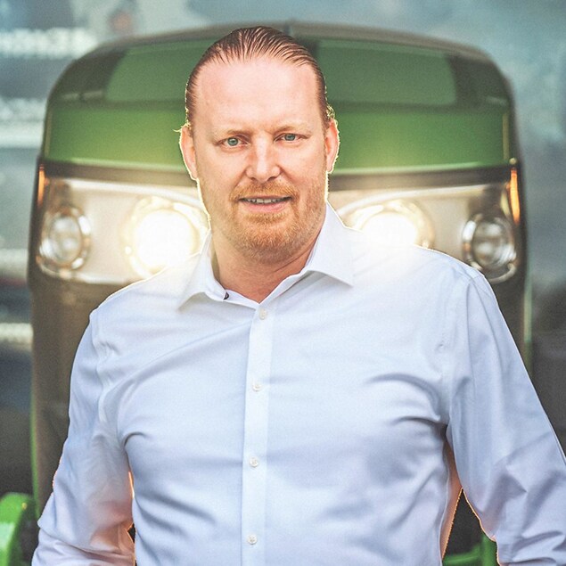 Dr. Martin Kremmer standing in front of a John Deere tractor