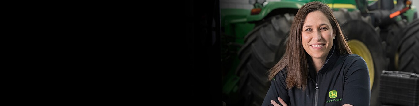 Margaux Ascherld standing next to a John Deere tractor