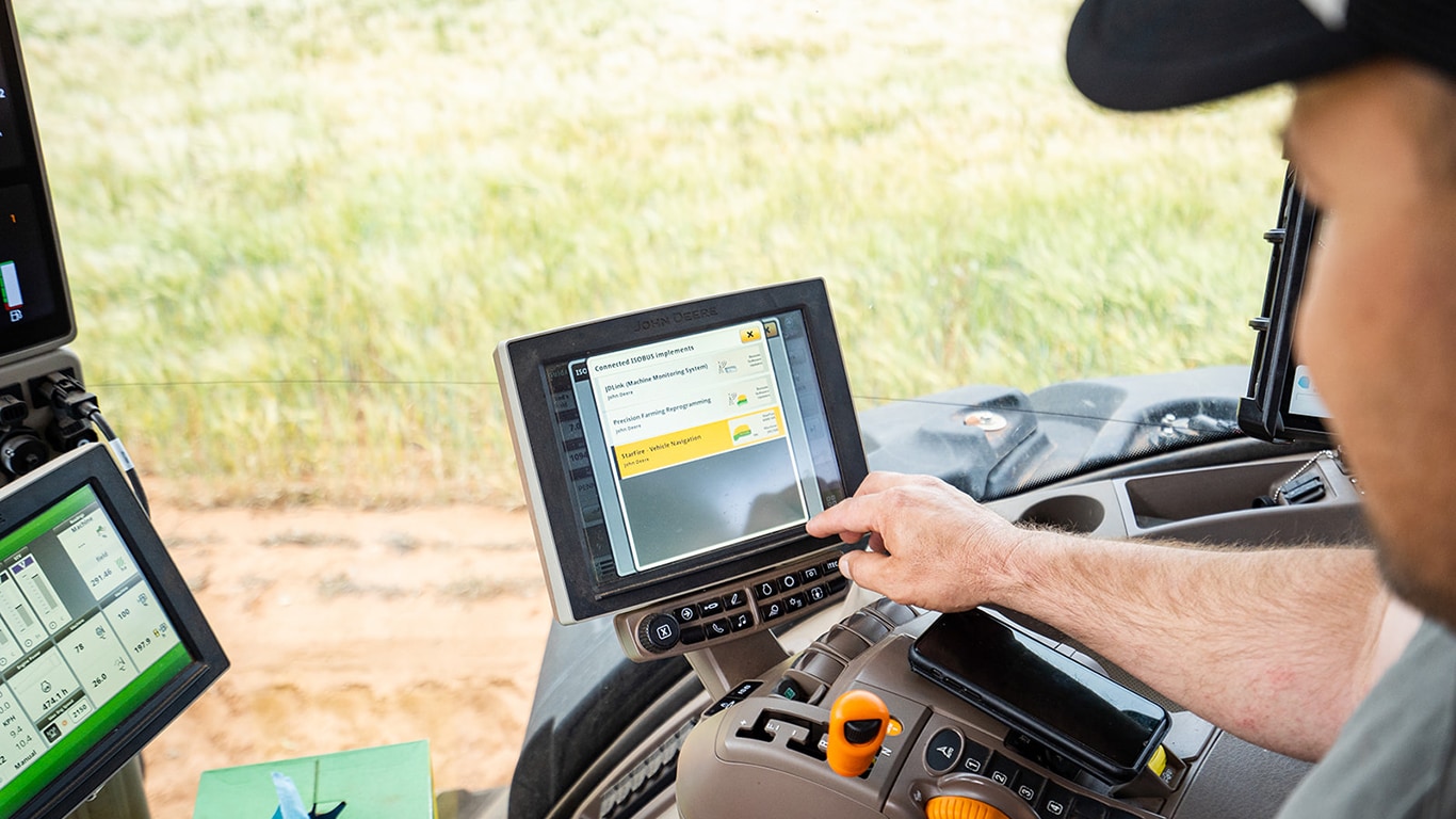 man using Remote Display in his tractor