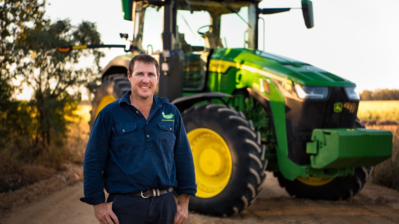 Chis Hutchinson standing in front of a tractor