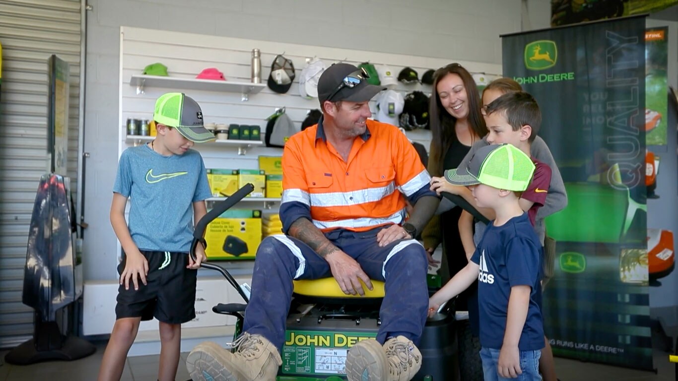 Father and children at John Deere dealership