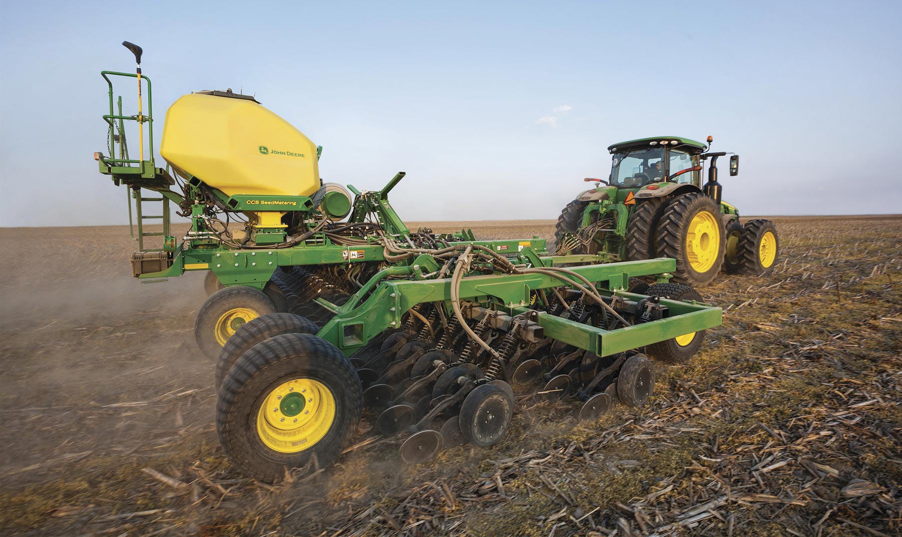 The improved N530C air drill attached to a tractor in a field