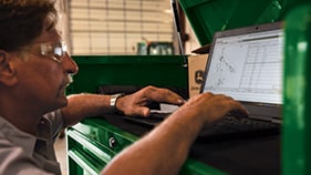 man at computer on floor shop