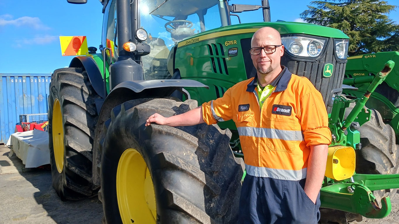 Tom Fyfe in front of John Deere equipment