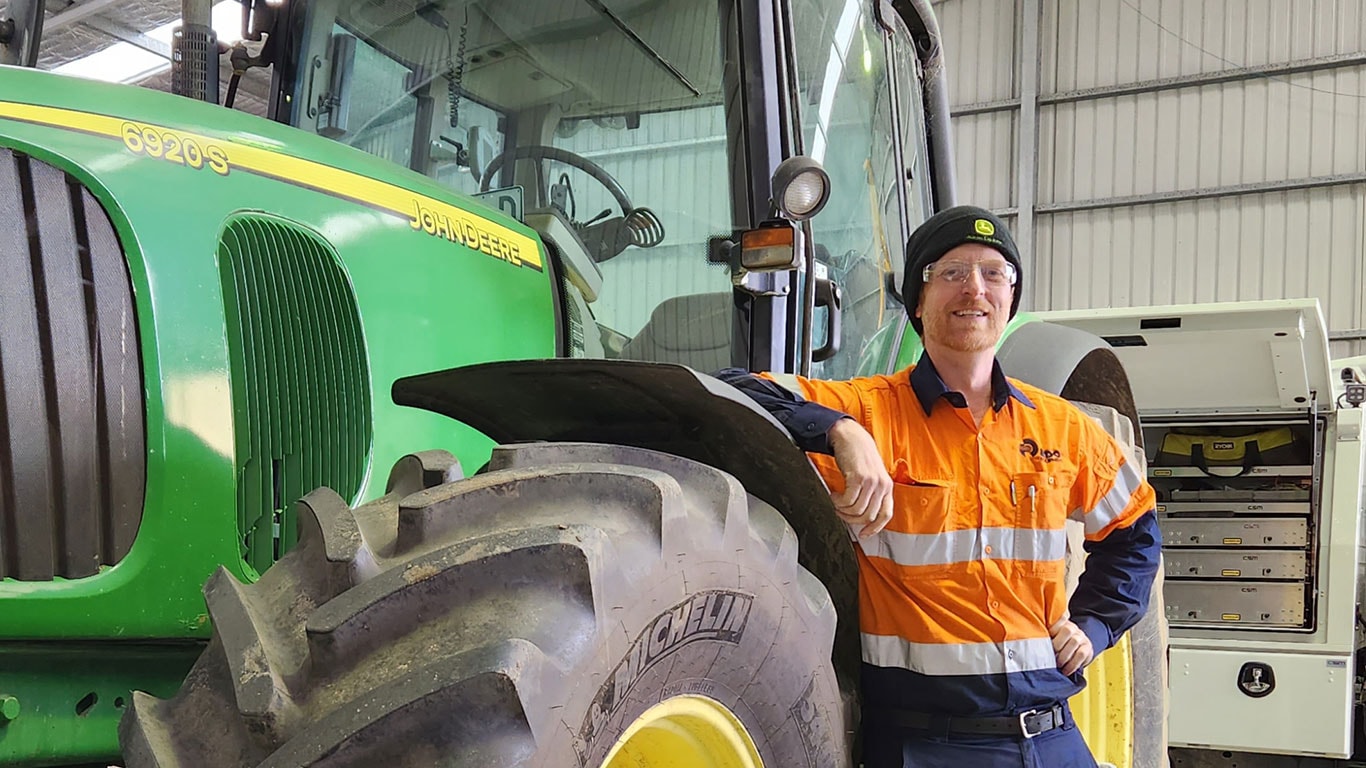 Vincent Powditch in front of John Deere equipment