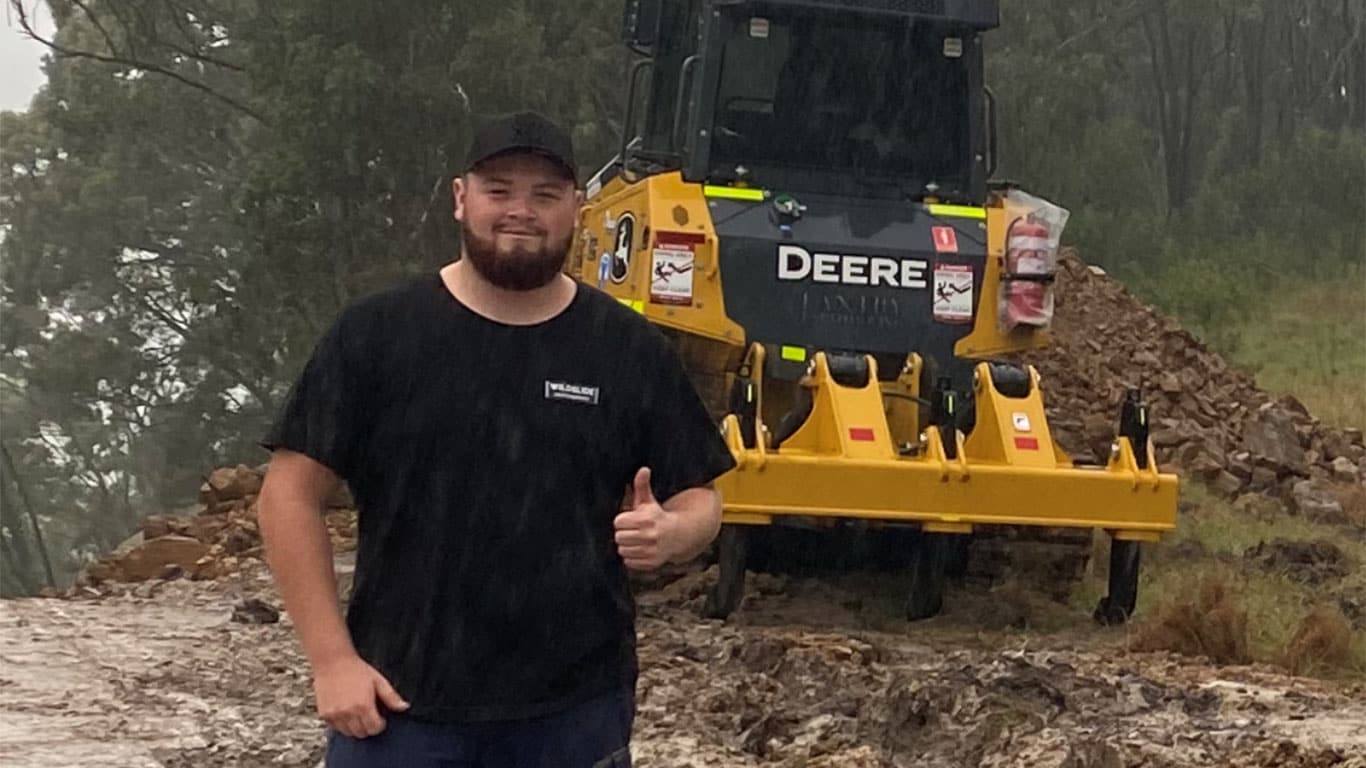 Hayden Cox in front of John Deere equipment