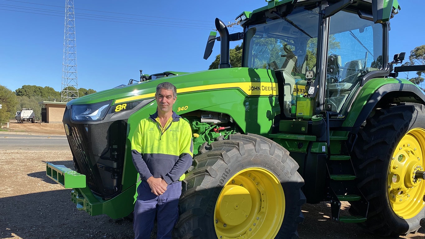 David Nicol in front of John Deere equipment