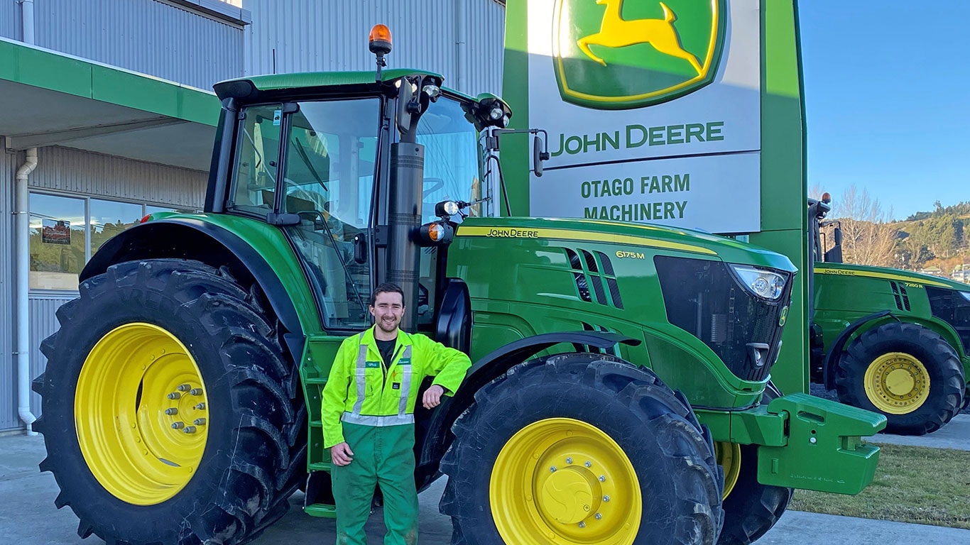 Greg Bishop in front of John Deere equipment