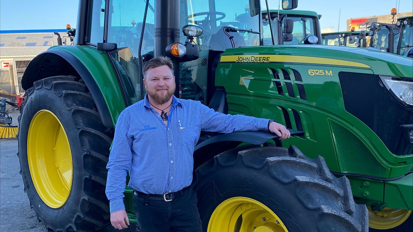 Jimmy O'Donnell in front of John Deere equipment