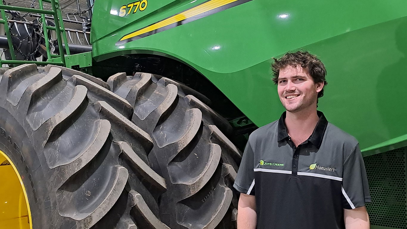 Lachlan Corridan in front of John Deere equipment