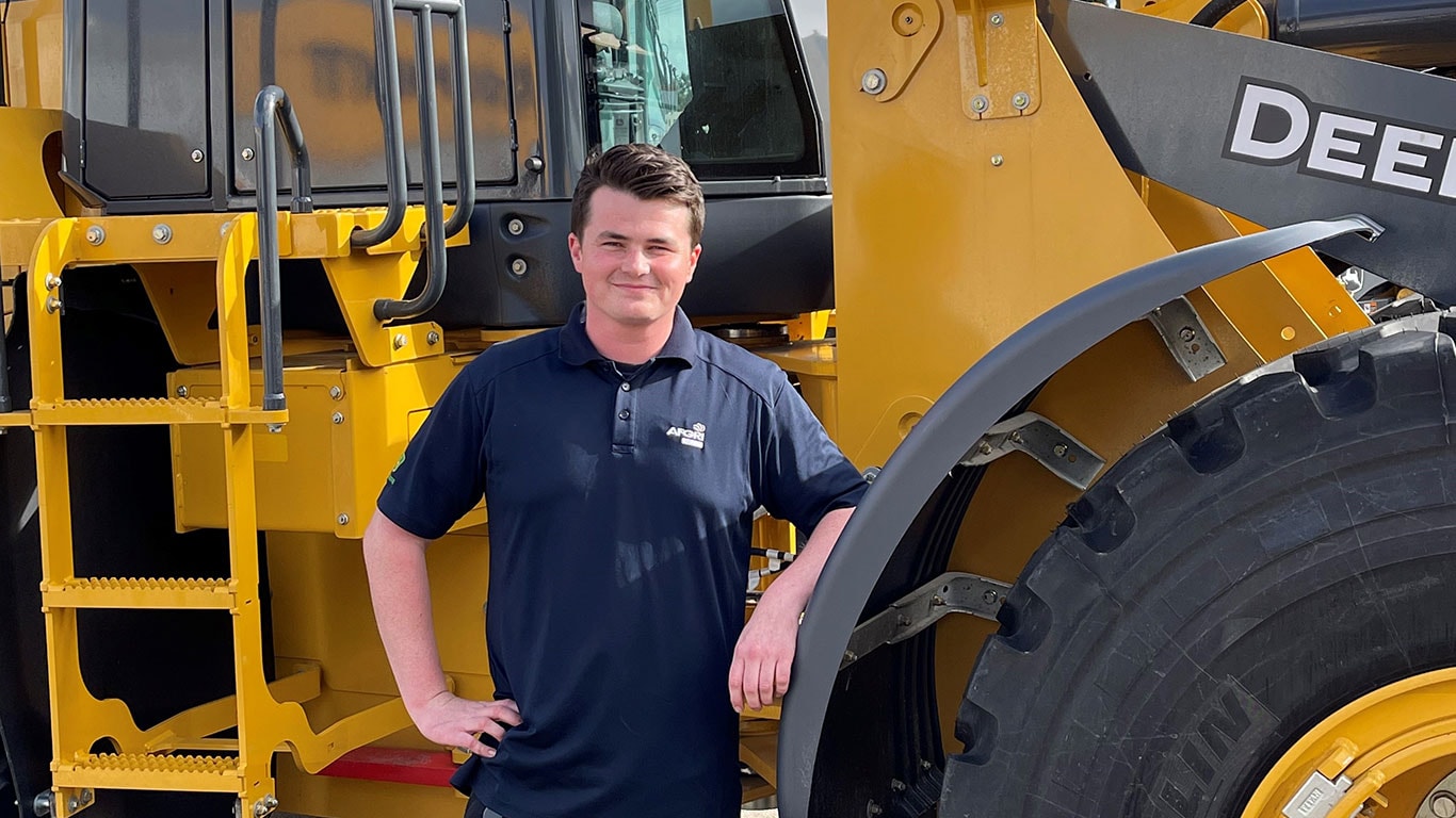 Mitchell Channer in front of John Deere equipment