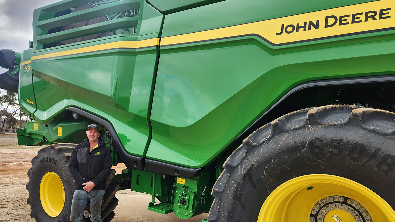 James Clarkson in front of John Deere equipment