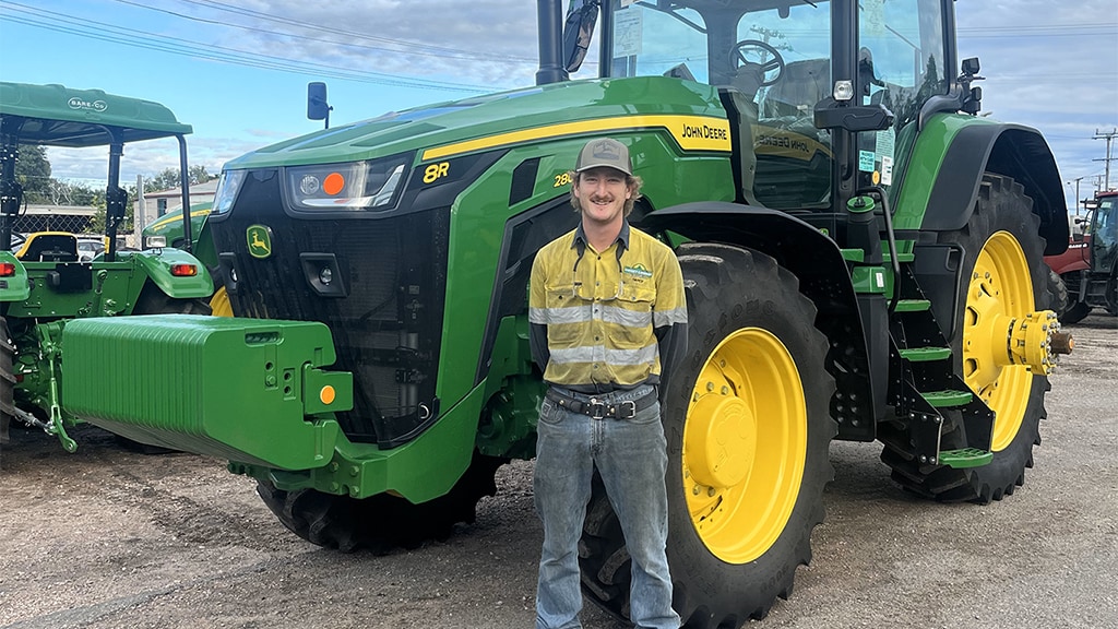 Darcy Miller posing in front of John&nbsp;Deere equipment