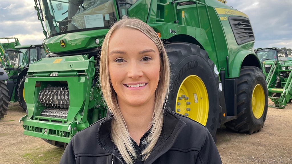 Sarah Lewis posing in front of John&nbsp;Deere equipment