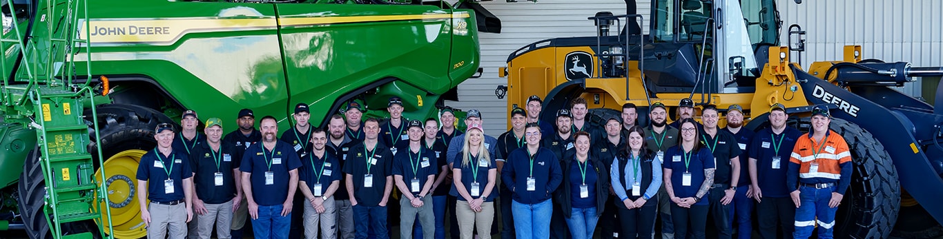 2024 Tech Awards candidates grouped in front of an X9 Combine and construction equipment