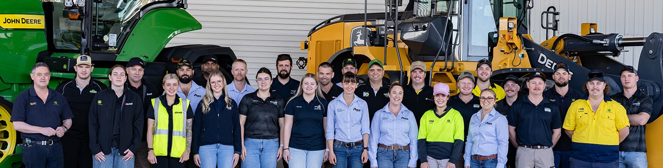 2025 Tech Awards candidates grouped in front of a tractor and dozer