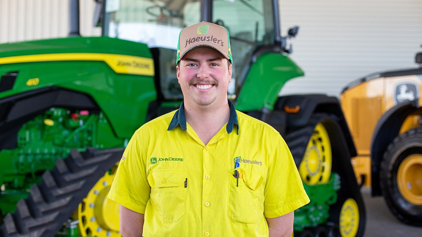 Henry standing with his hands behind his back in front of a 9RT 590 Tractor
