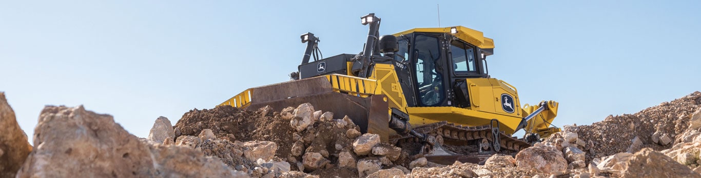 1050 P-Tier dozer on rocky terrain, actively maneuvering through large boulders