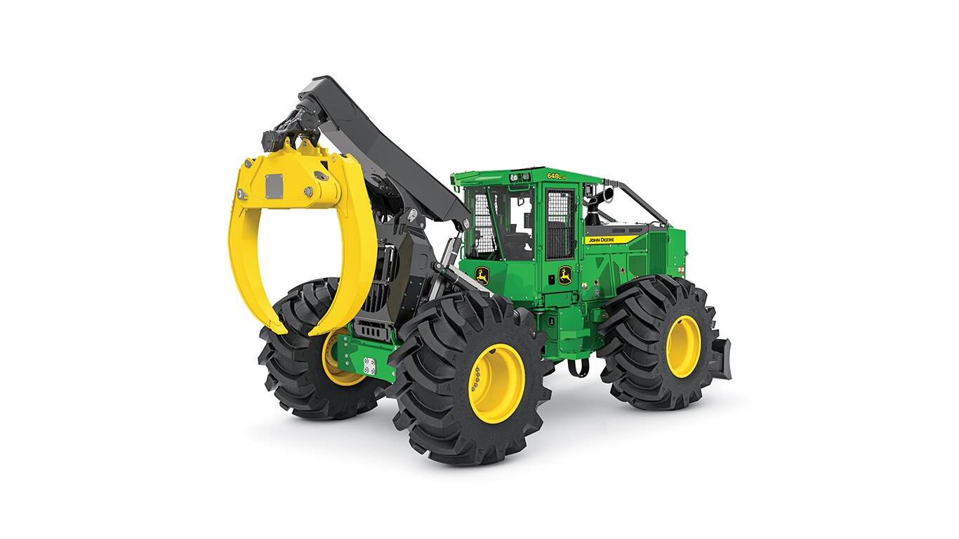Green John Deere forestry machine with yellow grapple and large heavy-duty tires.