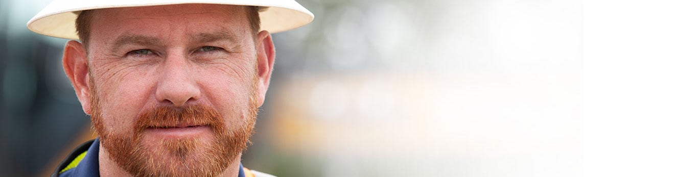 Darin Stroud wearing a hard hat, looking at the camera.