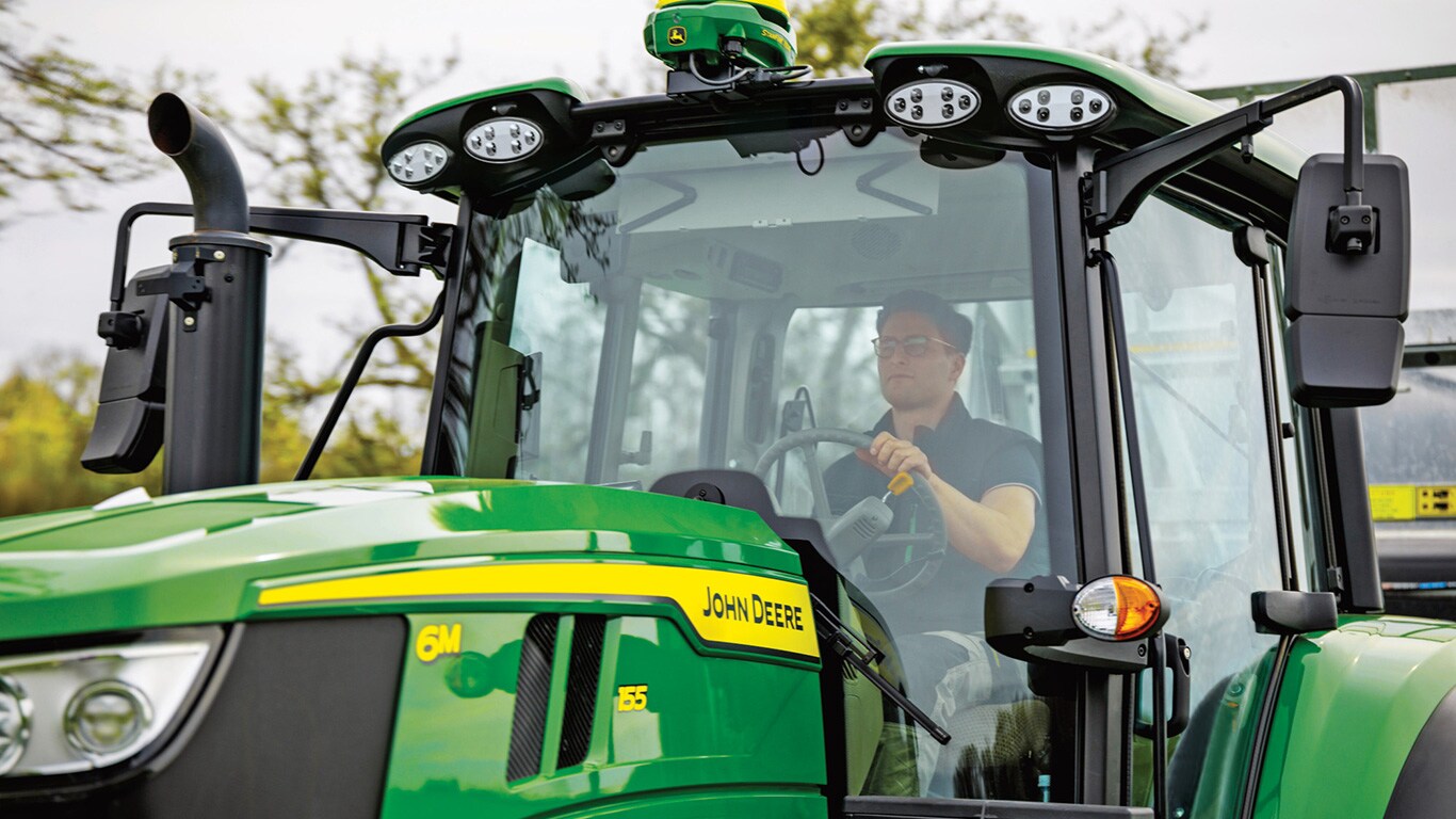 person driving 6M155 tractor