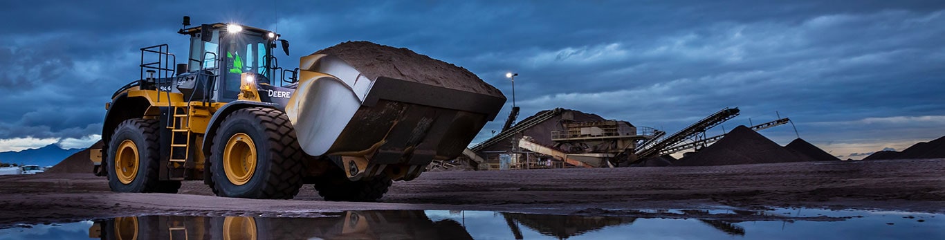 844L Aggregate Handler Loader with a mill operation in the background